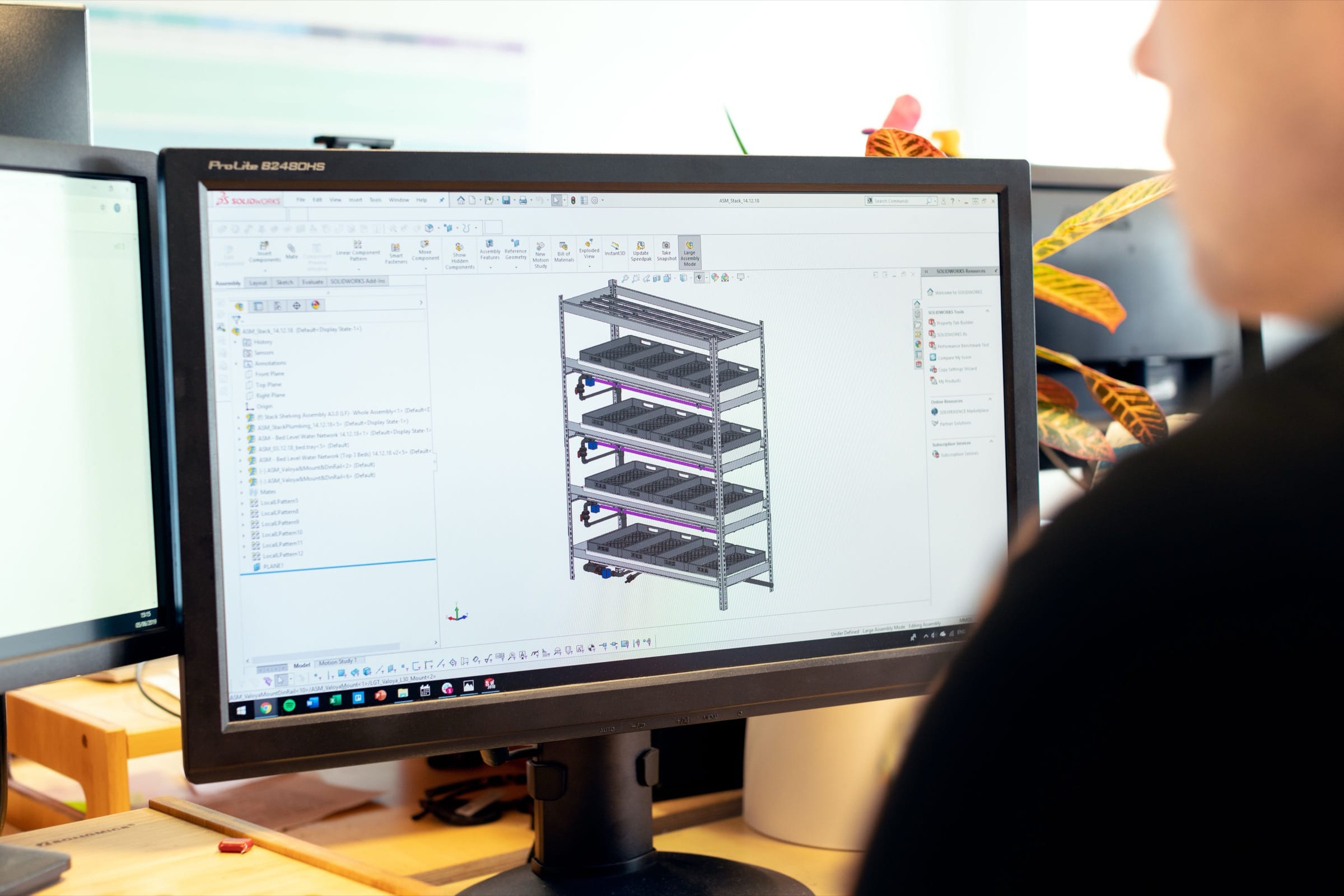 A CAD model of a welded frame on a monitor.